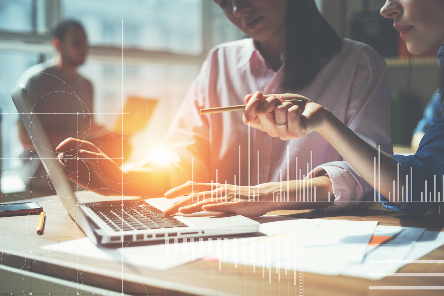 Team working on a project in loft office. Two women discussing marketing plan. Laptop and paperwork on the table. Statistic graph overlay, icon innovation interface